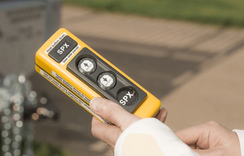 Handheld 50-foot hydraulic remote control used to operate portable aluminum bleachers for fast and efficient event setup.